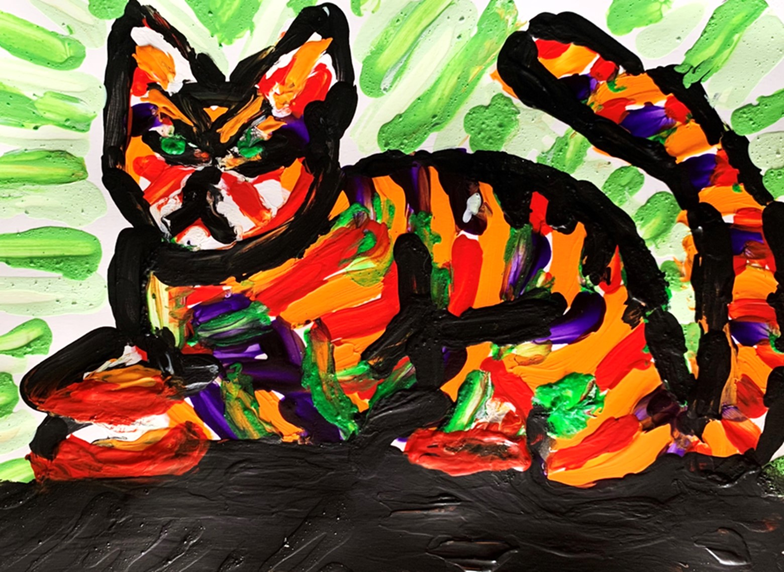 A mulitcolor, fingerpainted cat. 