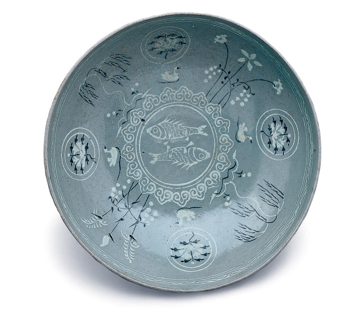 The image depicts a Korean celadon ceramic bowl with inlaid fish, bird, flower and plant designs